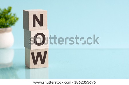 NOW message on light blue background. Now made with building blocks.
