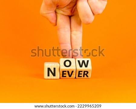 Now or never symbol. Businessman turns wooden cubes and changes the word 'never' to 'now' or vice versa. Beautiful orange background, copy space. Business and now or never planning concept.