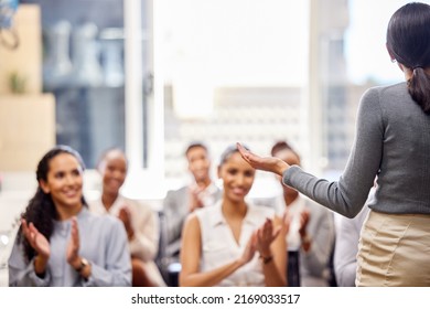 Now That Deserves A Round F Applause. Rearview Shot Of An Unrecognizable Young Businesswoman Giving A Presentation In The Boardroom.