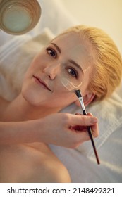 Now You Know My Secret To Glowing Skin. Portrait Of A Young Woman Getting A Facial Treatment At A Spa.