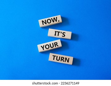 Now it's your turn symbol. Concept words Now it's your turn on wooden blocks. Beautiful blue background. Business and Now it's your turn me concept. Copy space