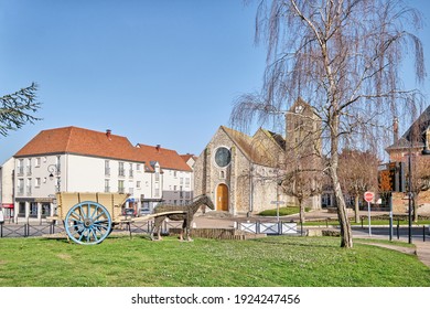 Nozay, France - February 24 2021 : Small Urban Park In Front Of A Church