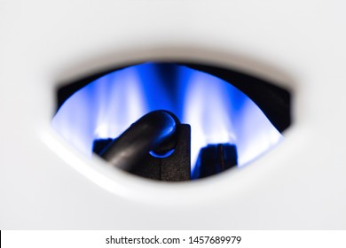 Nozzle and fire gas boiler close-up. white background. The boiler is in operation mode. you can clearly see the flames and gas nozzles. the concept of carbon monoxide leakage and poisoning. - Shutterstock ID 1457689979