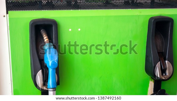 nozzle fuel in gas station, transport and travel\
concept, Green concept.