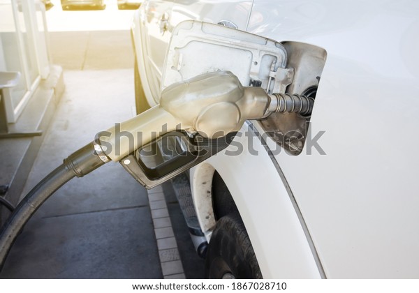 Nozzles in the\
gas station. A diesel dispenser that is filling up with a car that\
stops for fuel during the\
trip.