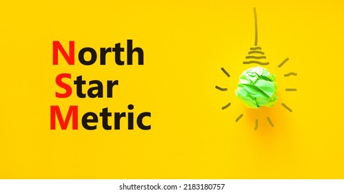 NSM North Star Metric Symbol. Concept Words NSM North Star Metric On Yellow Paper On A Beautiful Yellow Background. Green Light Bulb Icon. Business And NSM North Star Metric Concept. Copy Space.