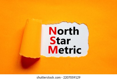 NSM North Star Metric Symbol. Concept Words NSM North Star Metric On White Paper On A Beautiful Orange Background. Business And NSM North Star Metric Concept. Copy Space.