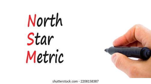 NSM North Star Metric Symbol. Concept Words NSM North Star Metric On White Paper On A Beautiful White Background. Businessman Hand. Business And NSM North Star Metric Concept. Copy Space.