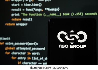 NSO Group Logo Seen On Smartphone Placed In Front Of Laptop With Simple Hacking Code. Selective Focus. Stafford, United Kingdom, July 19, 2021.