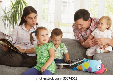 Nuclear Family: Parents With Three Children At Home Having Fun.