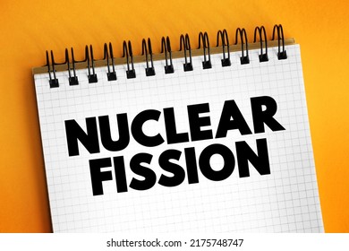 Nuclear fission - reaction in which the nucleus of an atom splits into two or more smaller nuclei, text concept on notepad