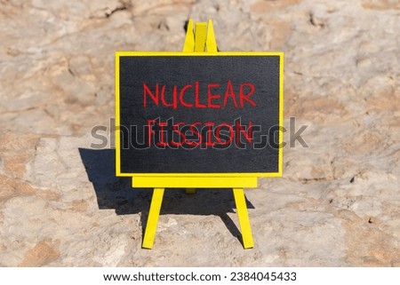 Nuclear fission symbol. Concept words Nuclear fission on beautiful black chalk blackboard. Chalkboard. Beautiful stone background. Business science nuclear fission concept. Copy space.