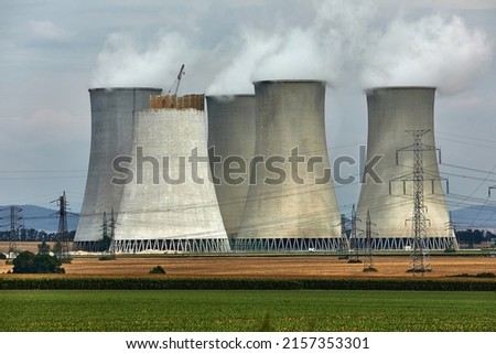 Nuclear Power plant with cooling towers through haze in the air