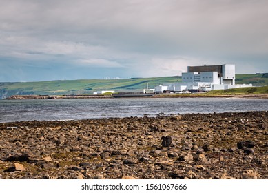 Nuclear Power Plant On The Coast With Cultivated Hills In Background On A Cloudy Spring Day. Dunbar, Scotland, UK.