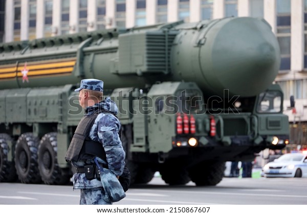 Nuclear\
weapon of Russia, soldier of russian military forces standing on\
background of strategic missile system in\
Moscow