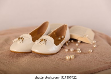 Nude Beige  Color Ladies Ballerina Flats Shoes Pair with Pearl Neckless and Book on beige Velvet Cloth