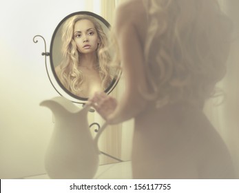 Nude Elegant Blonde Woman In Front Of The Mirror