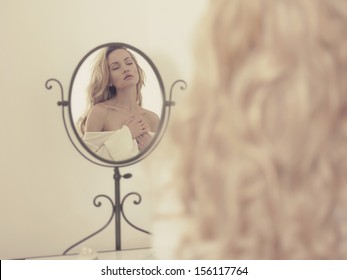 Nude Elegant Blonde Woman In Front Of The Mirror