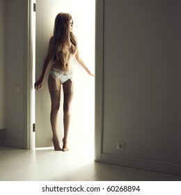 Nude Elegant Woman In A Luminous Doorway