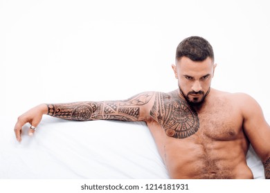Tatooed man on the bigbed alone