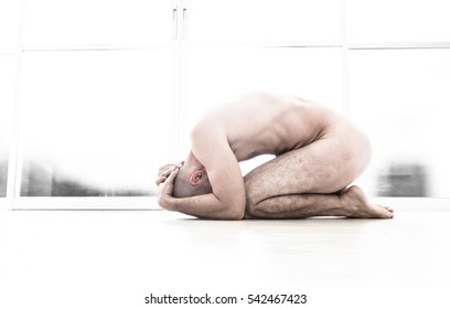 Nude Man With Fetal Position In White Room