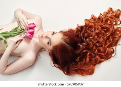 Nude Sexy Beauty Redhead Girl With Long Hair. Perfect Woman Portrait On Black Background. Gorgeous Hair And Deep Eyes. Natural Beauty, Clean Skin, Facial Care And Hair. Strong And Thick Hair. Flowers