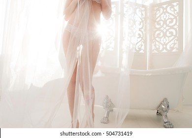 Nude Woman Hiding Behind Diaphanous Fabric In Bathroom. Sexy Female Body In White Lingerie, Free Space