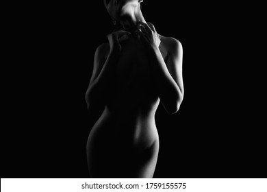 Nude Woman silhouette in the dark. Beautiful Naked Body Girl. Black and white portrait