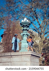 NUEVA YORK, UNITED STATES - Apr 01, 2019: A Vertical Shot Of A Female Taking A Photo Of Her Friend In A Graduation Gown In Columbia University