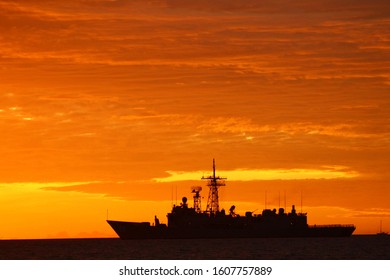 Nuku'alofa, Tonga, ‎4 ‎March ‎2019. Australian Navy Frigate And Small Yacht Caught In Silhouette Of A Golden Sunrise