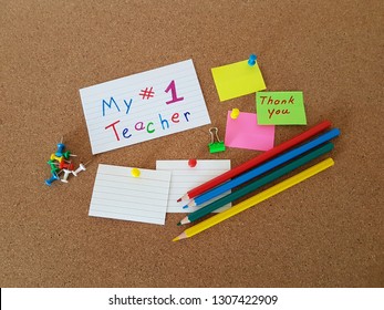 Number 1 Teacher Sign Pinned On A Cork Board, Note Pads And Colored Pencils Laying On A Cork Background, Teachers Appreciation Day, Thank You Teacher, Education, Memo Board