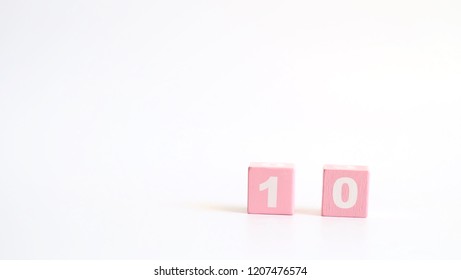 Number 10, ten, Pink wooden cube with number isolated on white background with copy space for text or word.