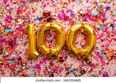 Number 100 Gold Birthday Celebration Balloon On A Confetti Glitter Background