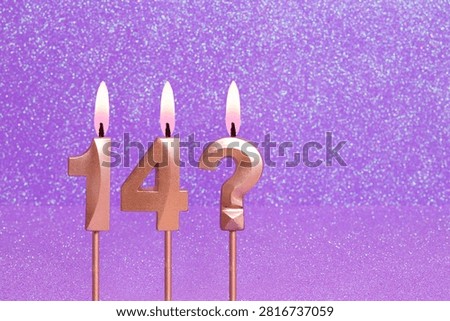 Number 14 and question mark on a pink background with blurred bright dots