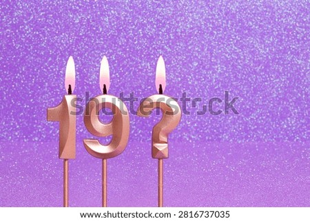 Number 19 and question mark on a pink background with blurred bright dots