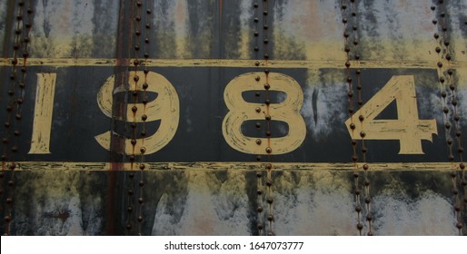 Number 1984 1 9 8 4 in Yellow on Blue Gray Riveted Metal Grunge Vintage Patina Dystopia Orwell