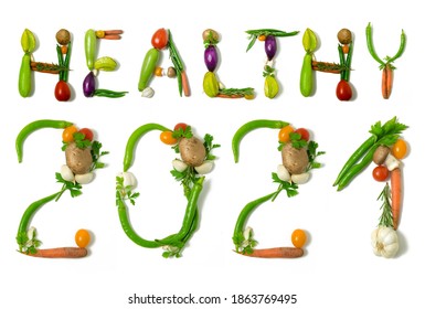 Number 2021 And Healthy Written With Vegetables, Concept For Healthy Food, Living, Covid 19, Coronavirus Prevention. Isolated On White Background. Happy New Year. End Of The Year Resolution