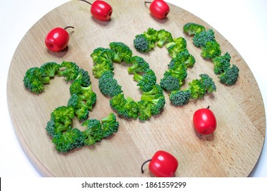 Number 2021 Made Of Broccoli On Wooden Cutting Board With Red Toys Isolated On White. Merry Christmas Or New Year Food, Menu, Diet. Vegetables, Healthy Nutrition.