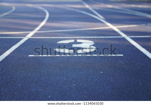 Number 3 start position of an outdoor
stadium running track with white dividing
lines