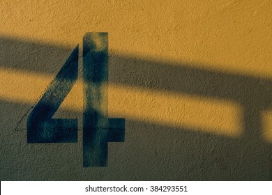 The Number 4 On The Wall Under The Shadow Of The Lights