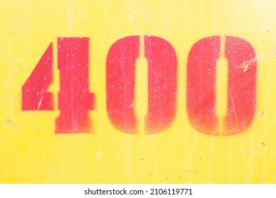 A number 400 in red on yellow, painted in an irregular pattern on an iron base. graphic design resources