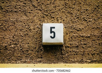 Number 5 Door Sign On Brown Facade