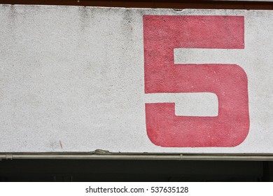 Number 5 Painting With Red Color On The Building