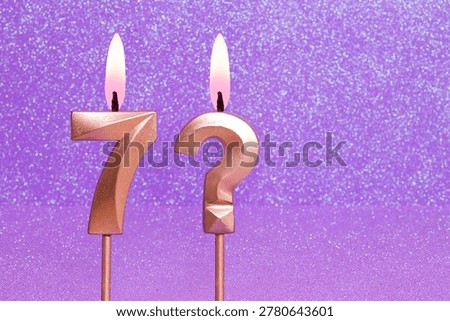 Number 7 and question mark on a pink background with blurred bright dots - Birthday or anniversary card with abstract blurred dots that glow