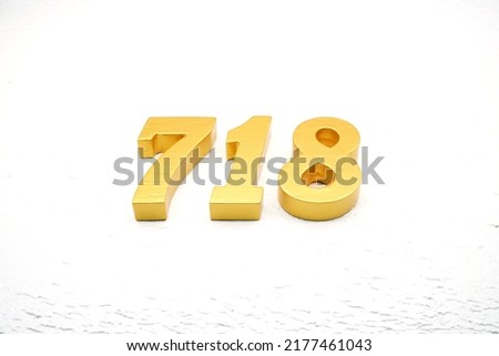    Number 718 is made of gold painted teak, 1 cm thick, laid on a white painted aerated brick floor, visualized in 3D.                              