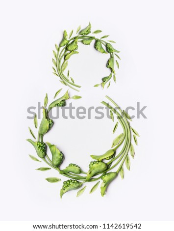 Green wreath with flowers and plants on white