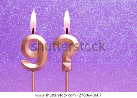 Number 9 and question mark on a pink background with blurred bright dots - Birthday or anniversary card with abstract blurred dots that glow