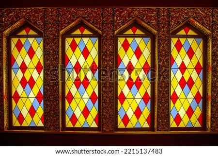 A number of antique stained glass windows of colored vertical in the form of rhombuses of red yellow blue color. Architecture, elements, style, Middle Ages.