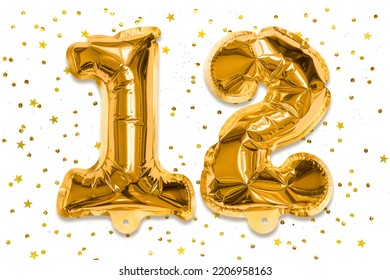The Number Of The Balloon Made Of Golden Foil, The Number Twelve On A White Background With Sequins. Birthday Greeting Card With Inscription 12. Numerical Digit, Celebration Event.