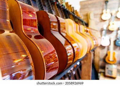 A number of classic acoustic guitars in the music store. - Shutterstock ID 2058926969